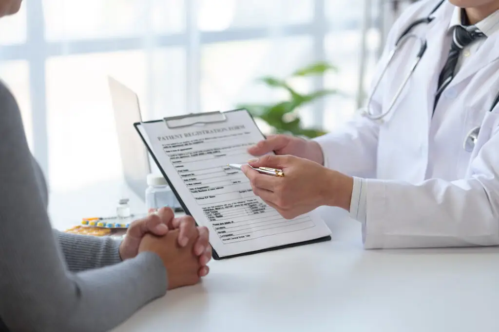 Medical service worker or doctor, pharmacist talking about medical test results at table in clinic Giving advice on how to take medicine to female patients, explaining prescriptions. Health care.